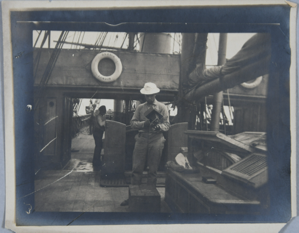 Image: Men on board SS Erik, one with camera